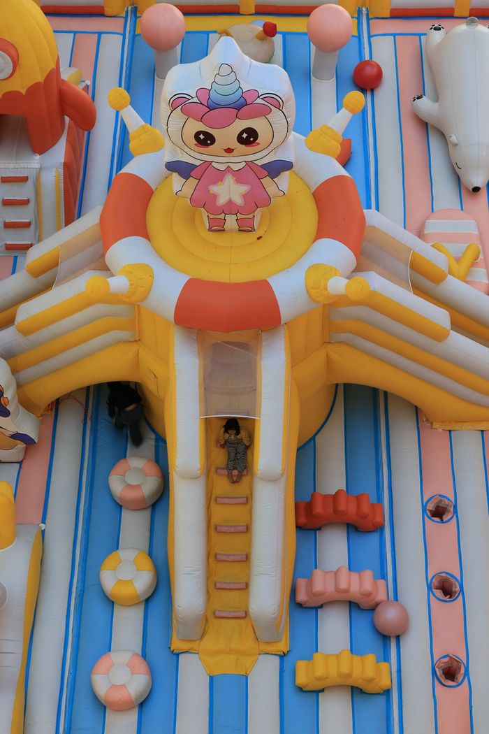 Top view of a vibrant inflatable playground featuring cartoon designs, ideal for children.