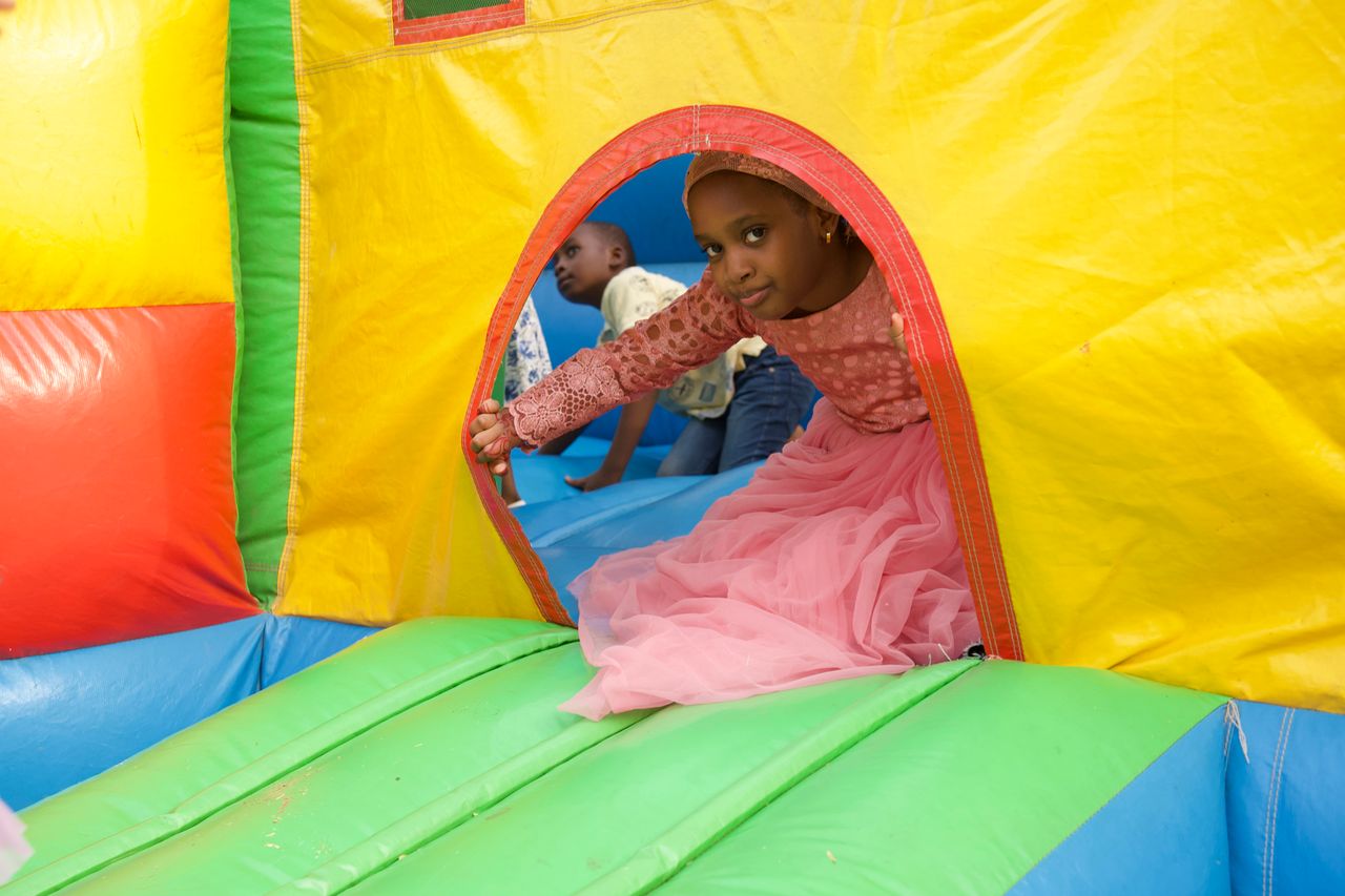 service-01 A child enjoying a birthday celebration in a colorful bouncy castle in Abuja, Nigeria.